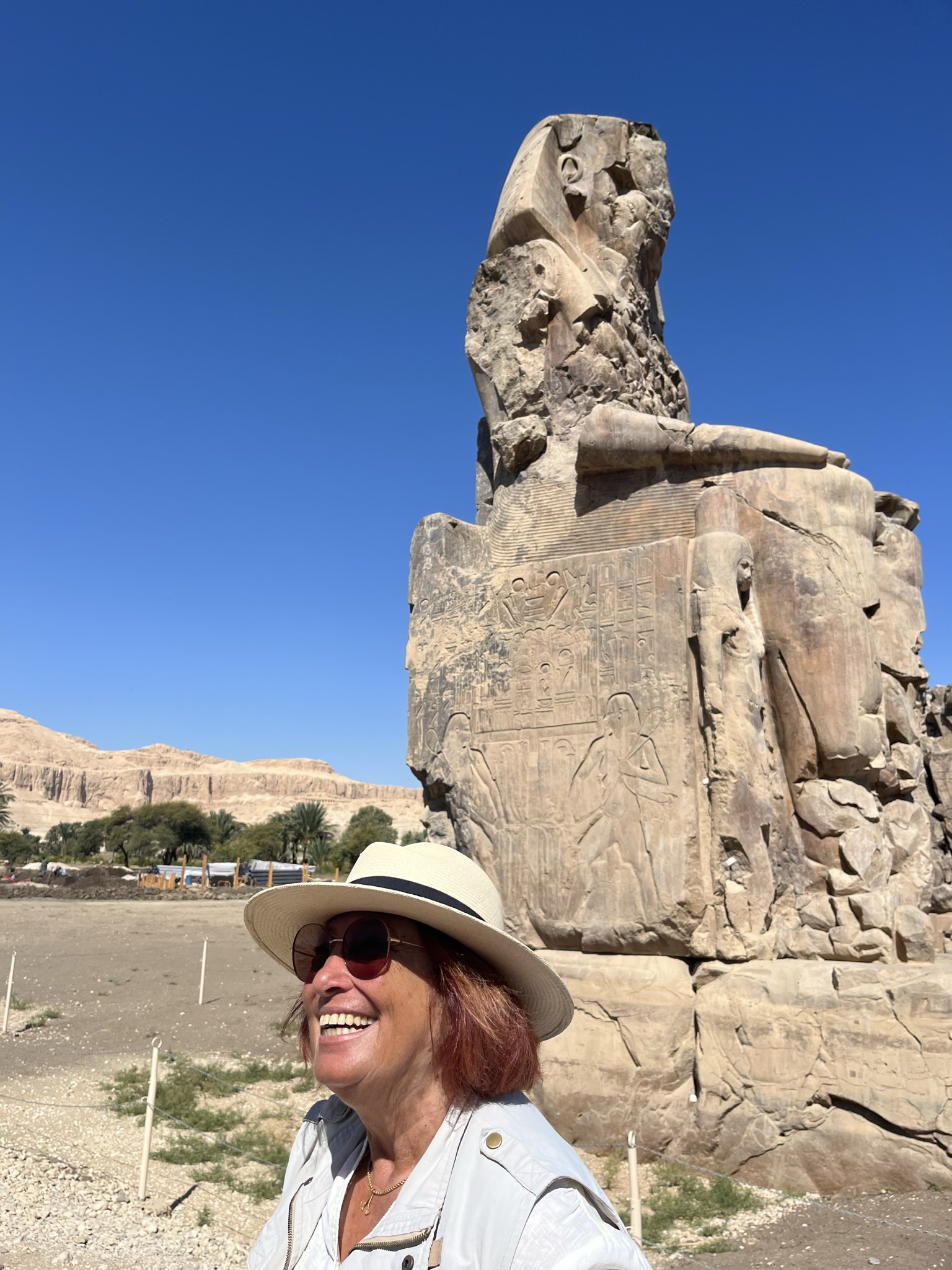 Dr. Hourig Hourouzian, archaeologist smiling at the Colossi of Memnon