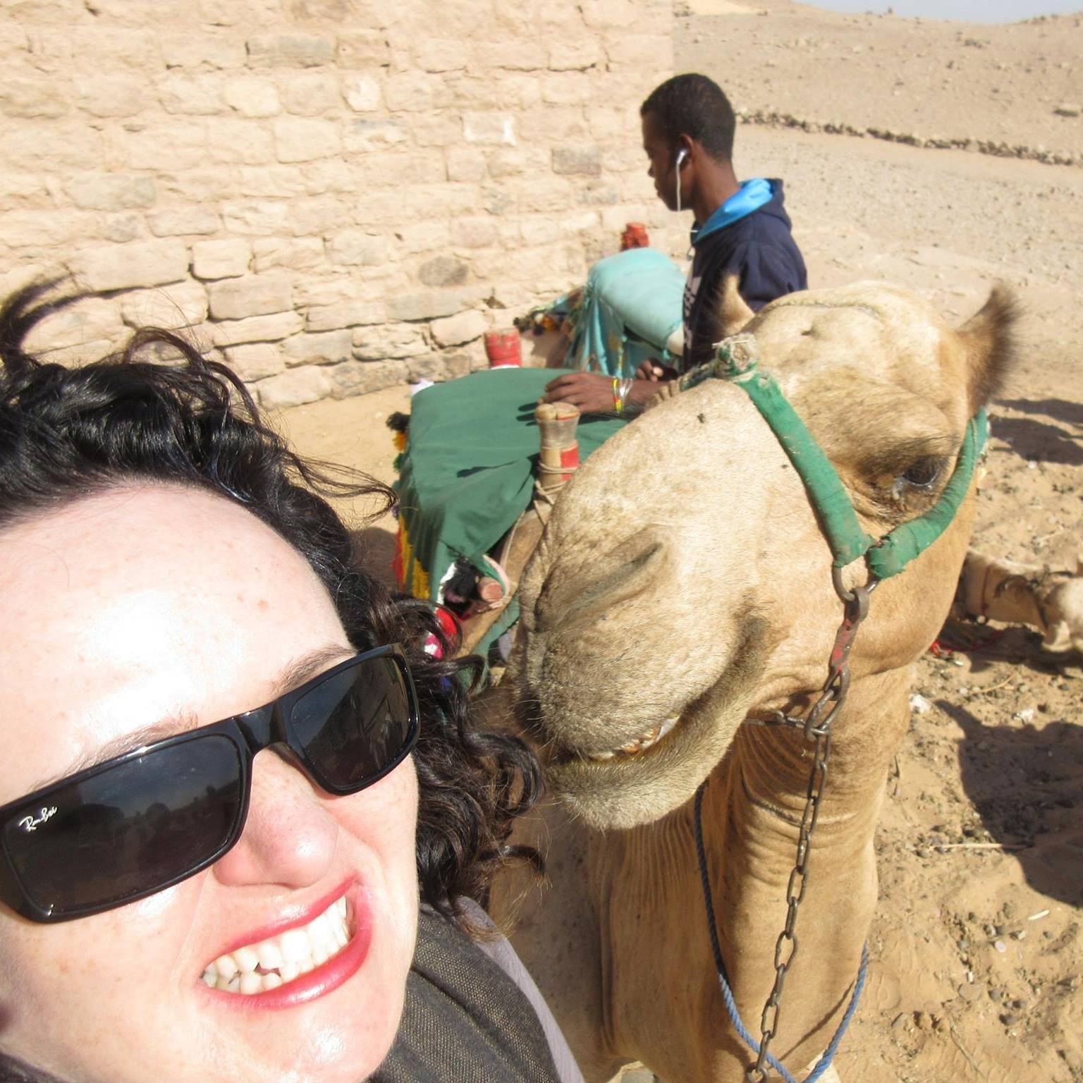 Laura in Egypt with a Camel and locals