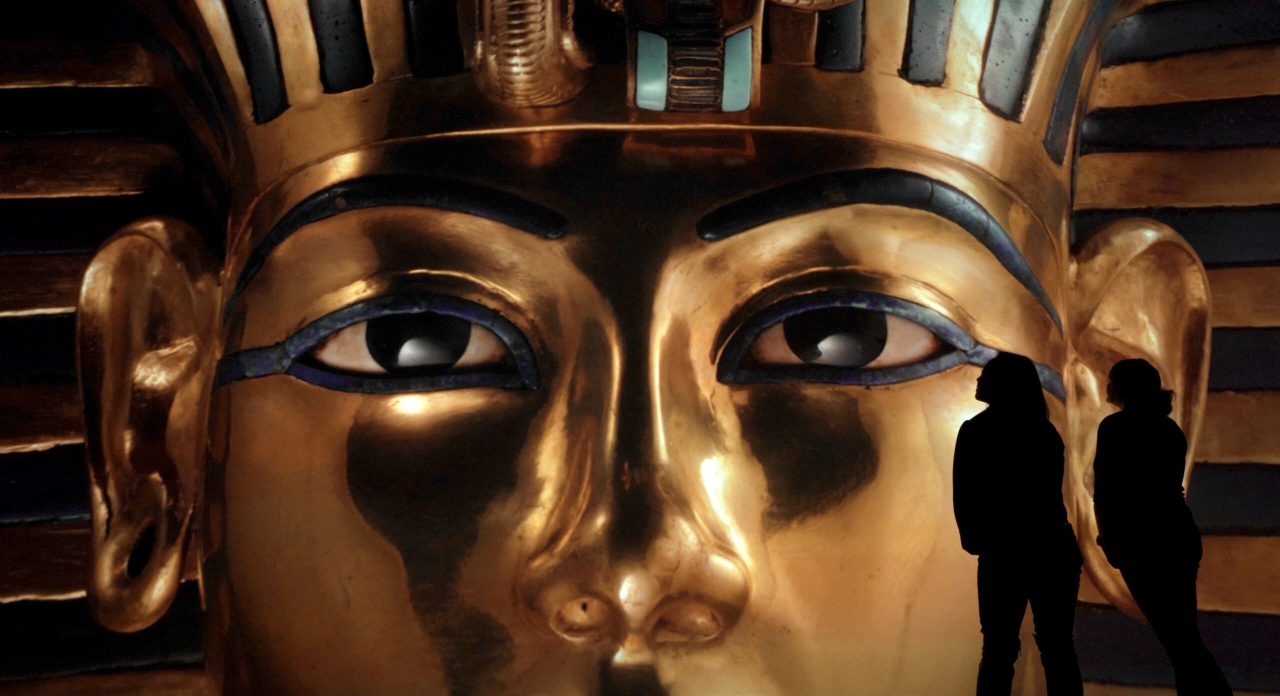 Close up of Tutankhamuns mask on large wall at the Beyond King Tut exhibit, Boston
