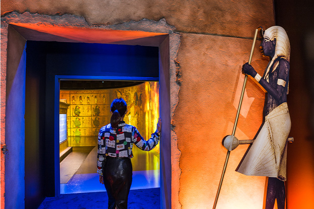 Image of woman entering into the Beyond King Tut Immersive experience 