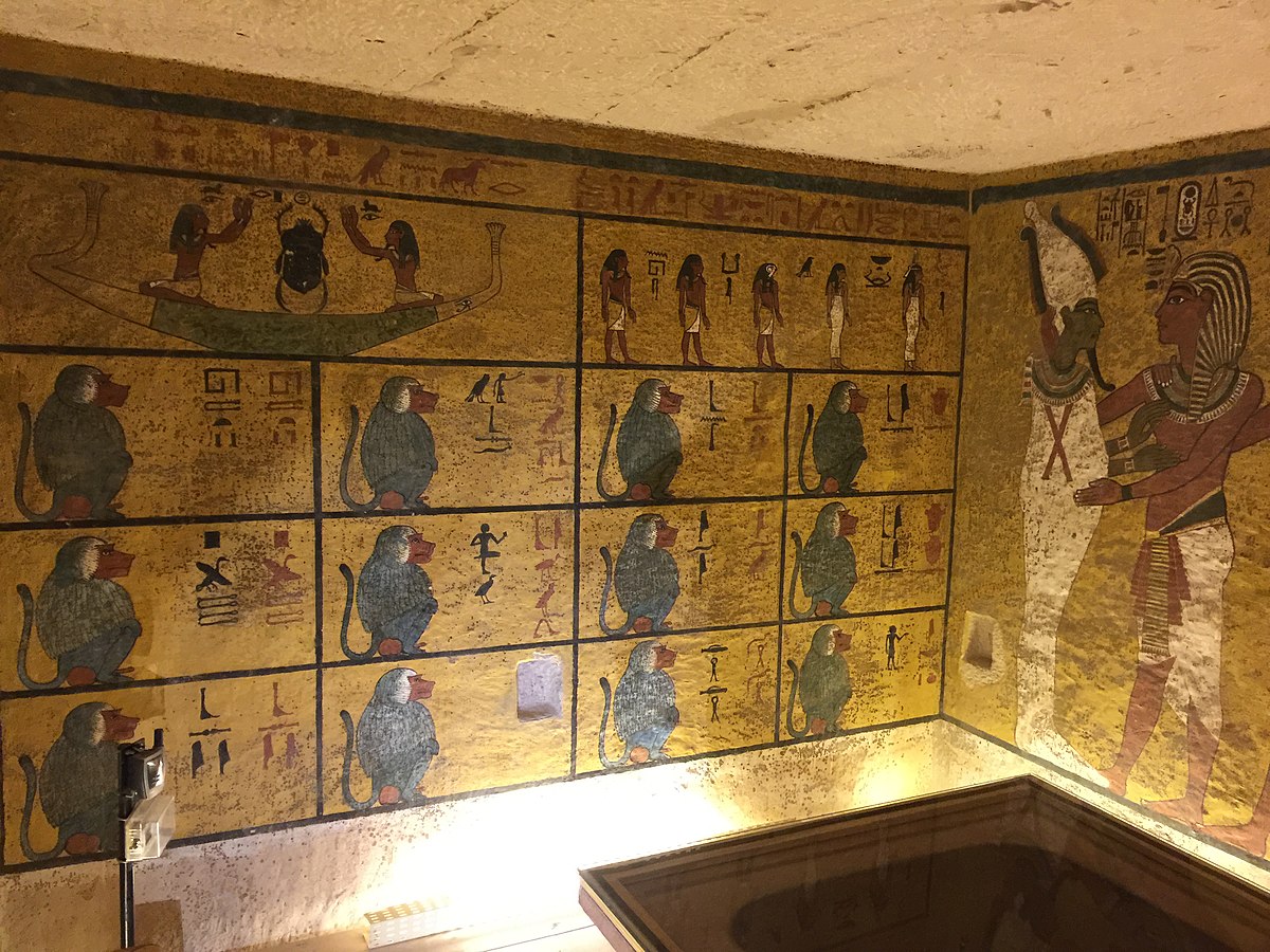 Image inside Pharaoh Tutankhamun´s tomb. The wall is covered with images from the first hour of the Book of the Amduat. Different baboons, divided in squares, covered the wall. 