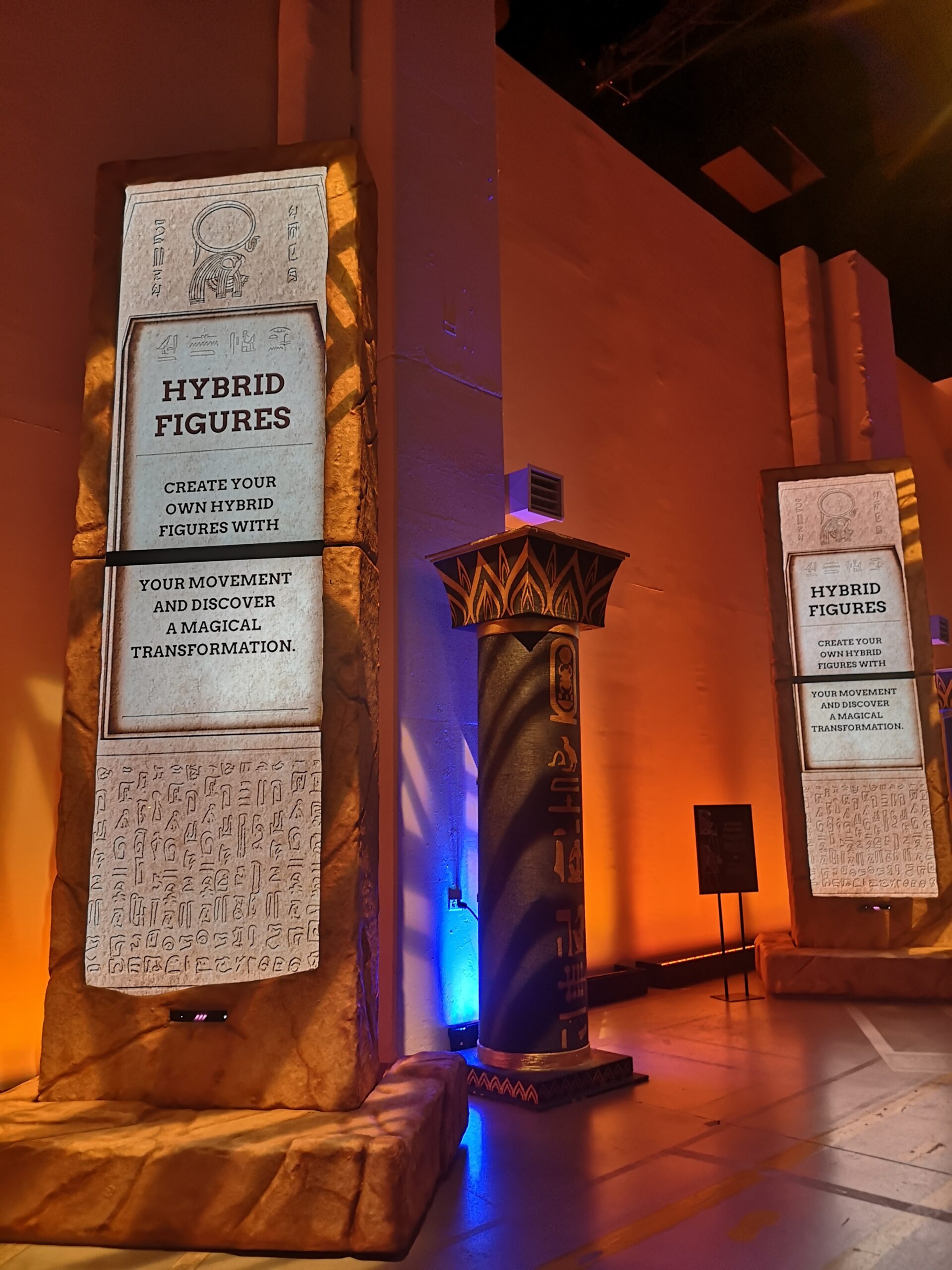 Image from the interactive game of Immersive Tut at the entry. It consists of a pillar with a screen in the middle where you can play the game.