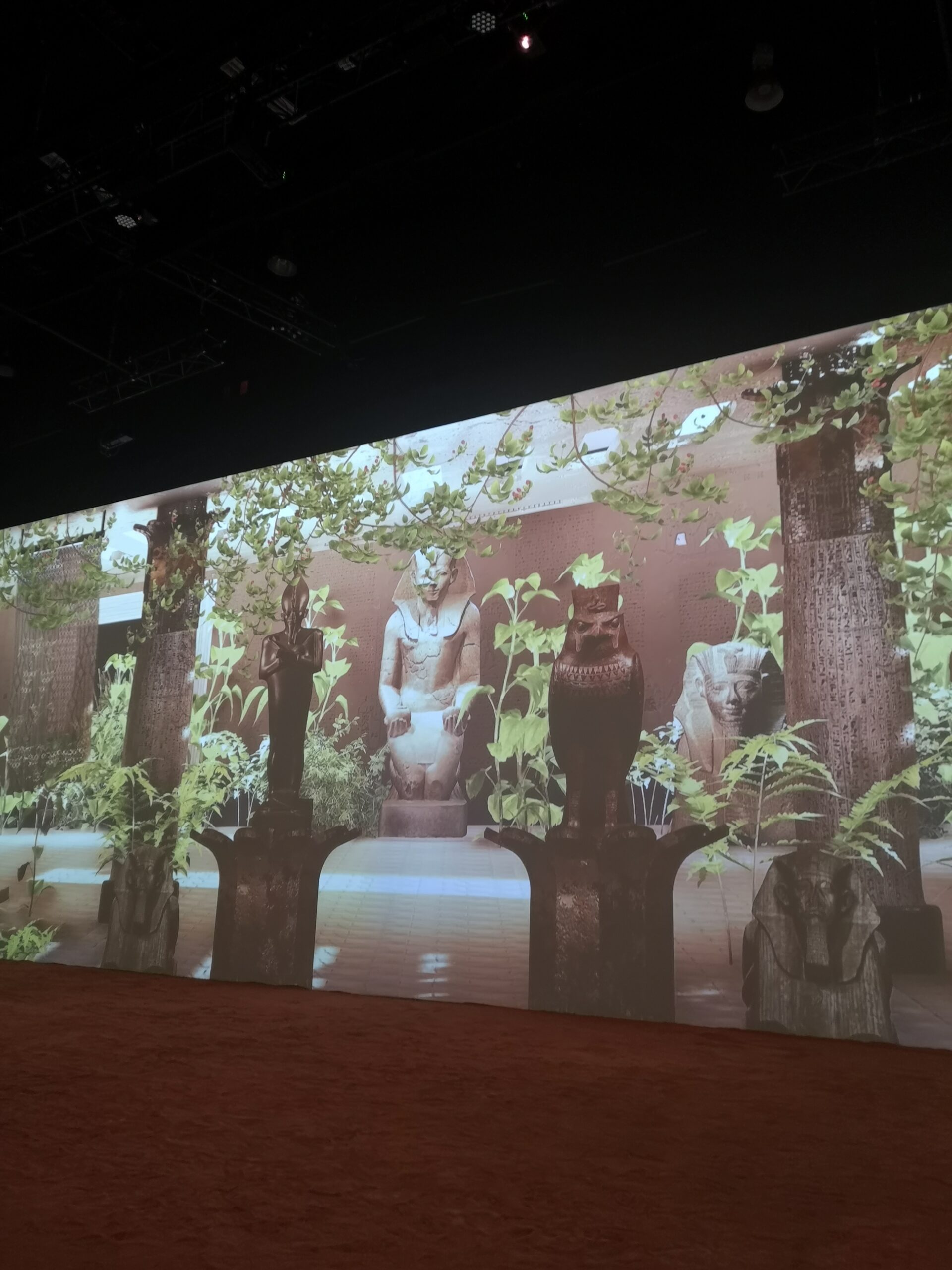Image of Immersive Tut. A garden with different ancient Egyptian statues appears on the wall.