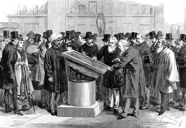 Image of a group of men gathered around the Rosetta Stone. The Second International Congress of Orientalists is examining the stone.